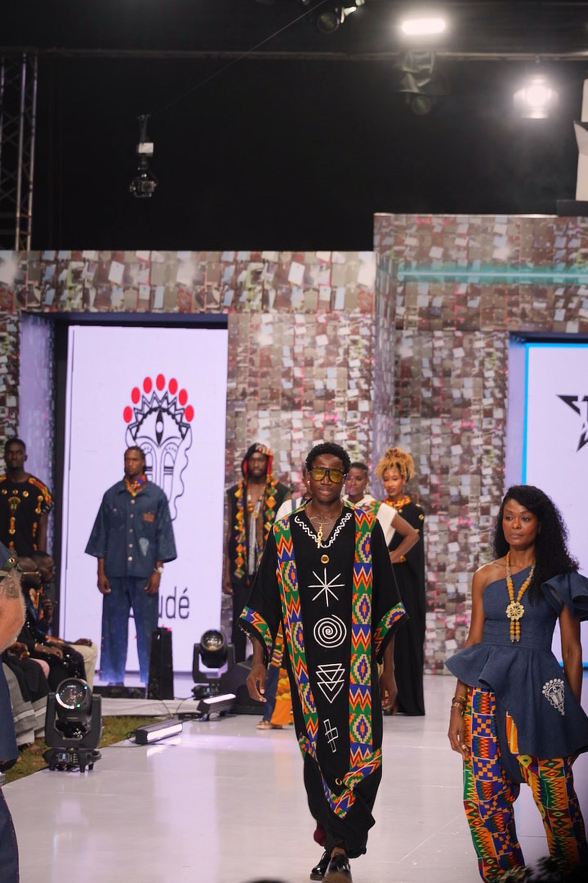 A group of models in printed designs at the head of the runway