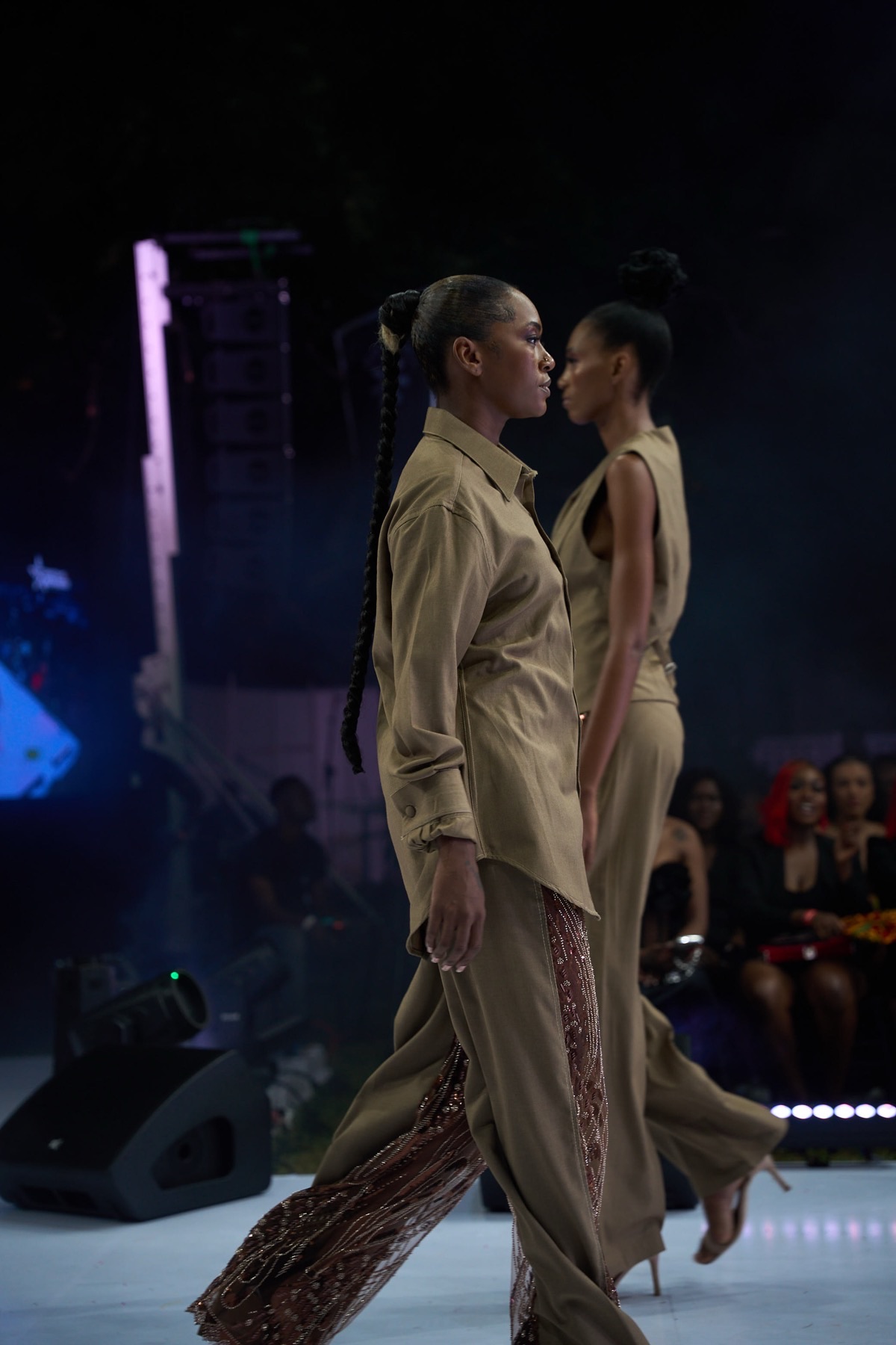 Two models passing on the runway