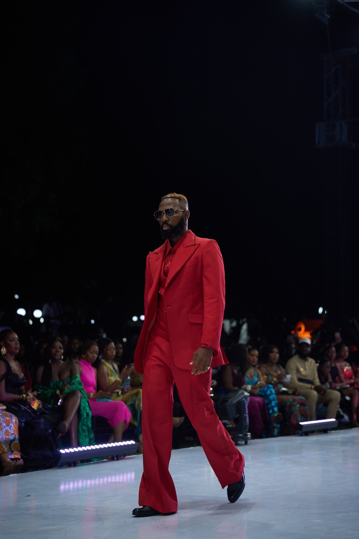A model in a red tailored suit