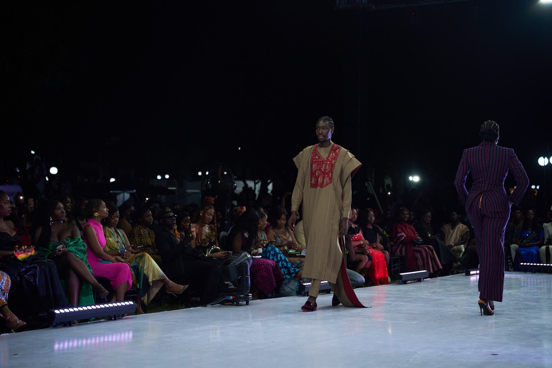 Models on the runway in front of a seated audience