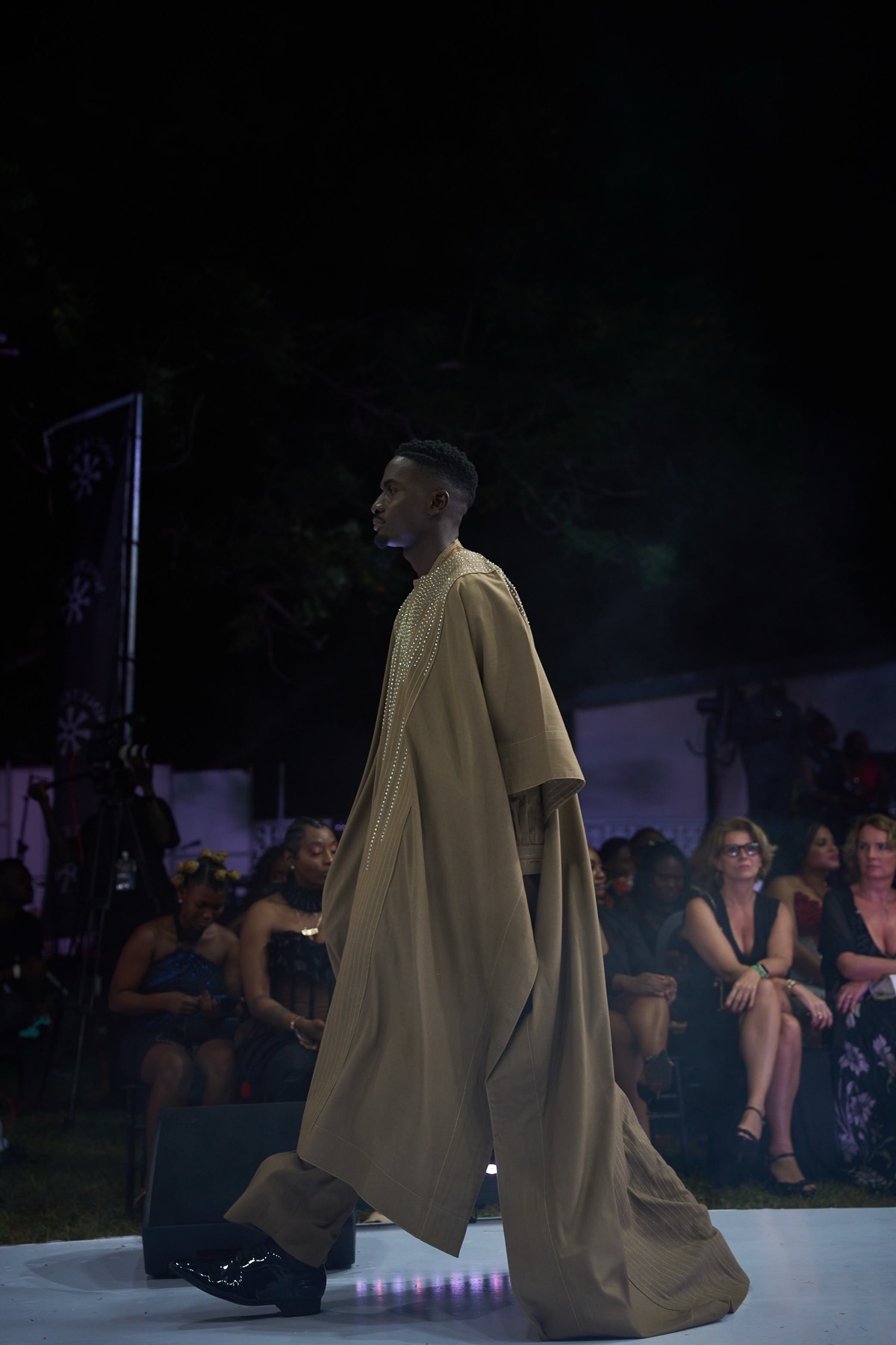 A model in a draped tan robe