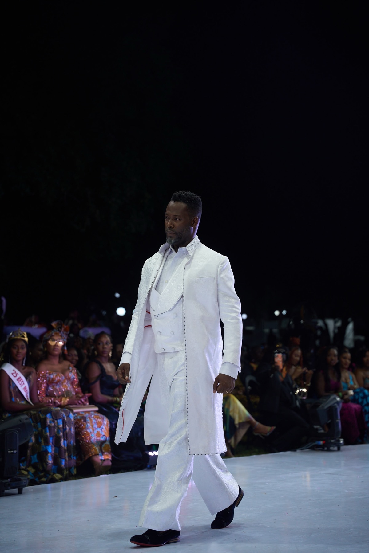 A model in a white longline coat