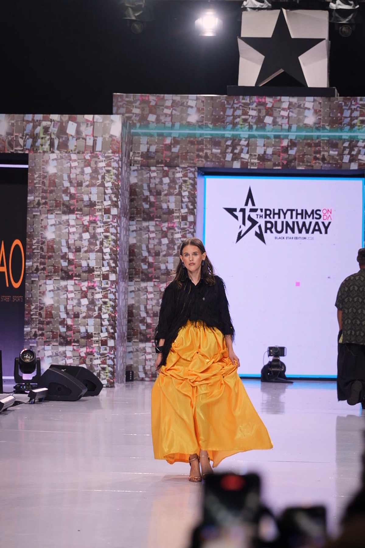A model in a full yellow skirt
