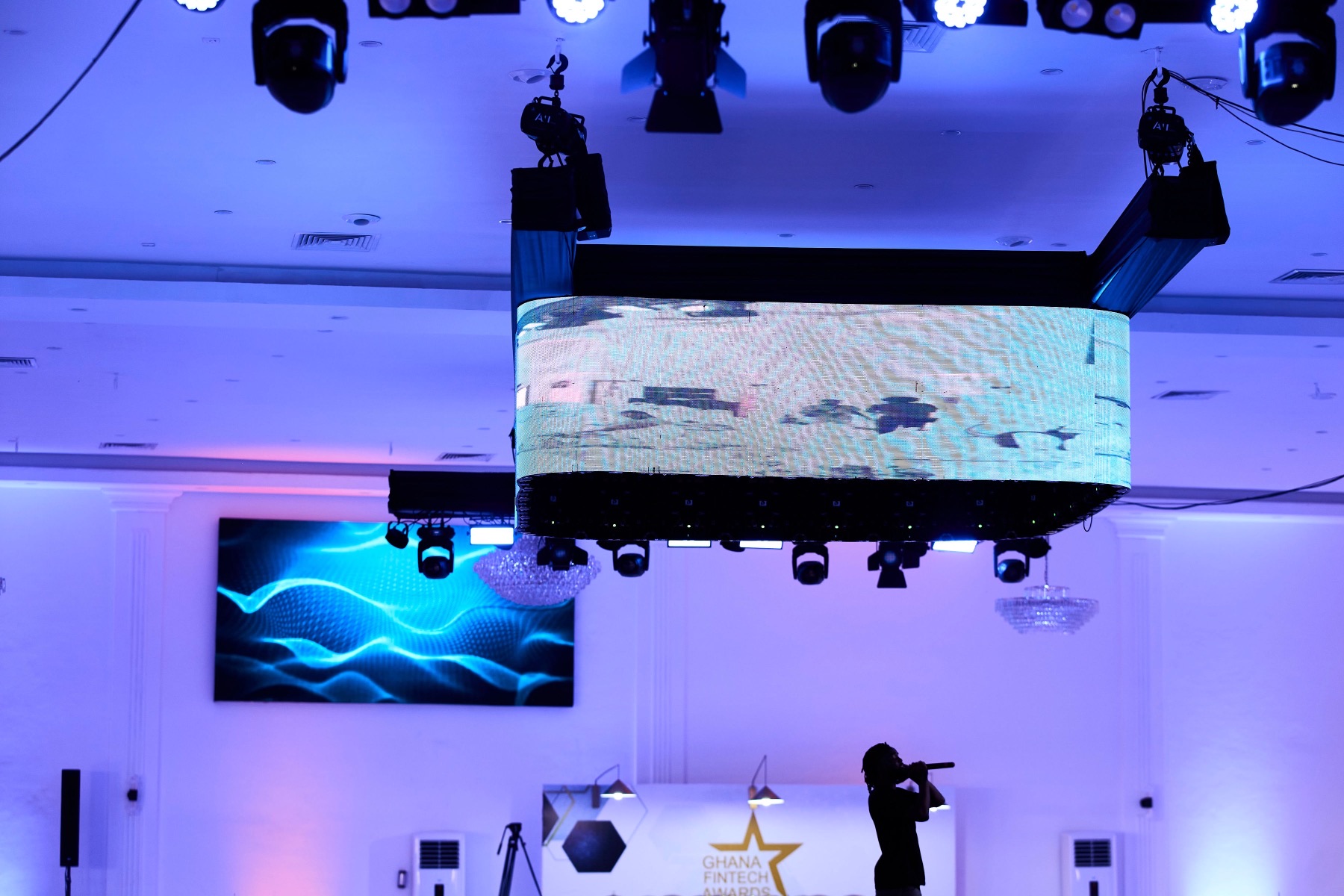 The flown screen and lighting rig above the floor