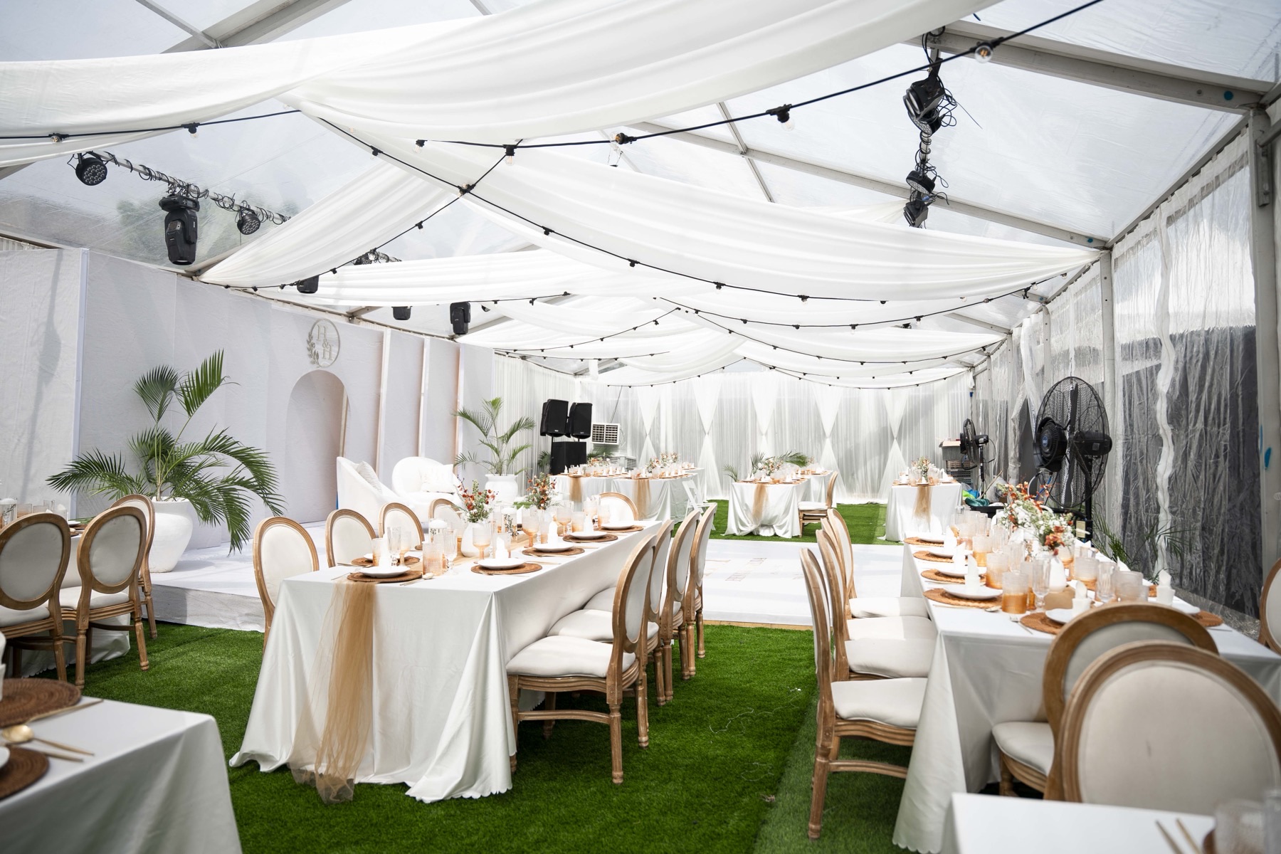 A draped marquee set for a wedding reception