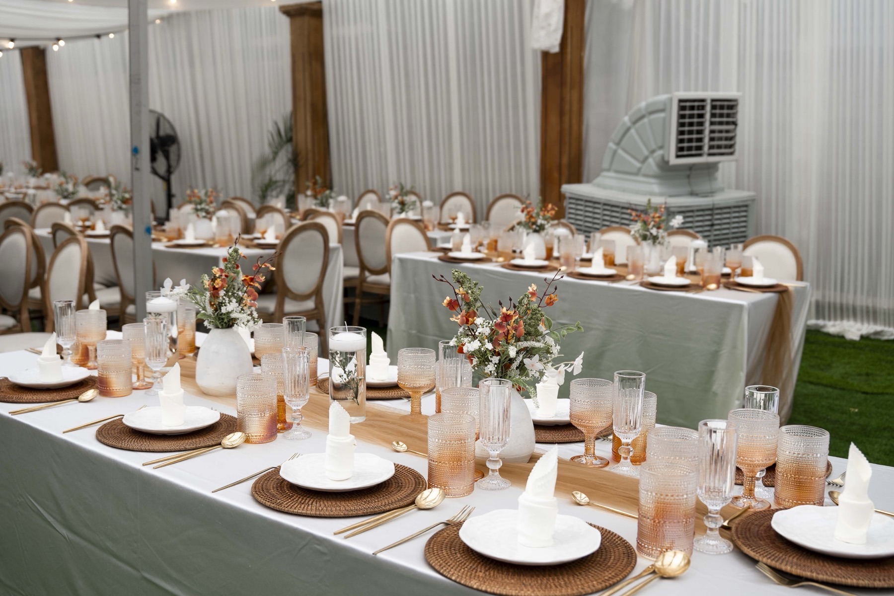 A long banquet table set with florals and glassware